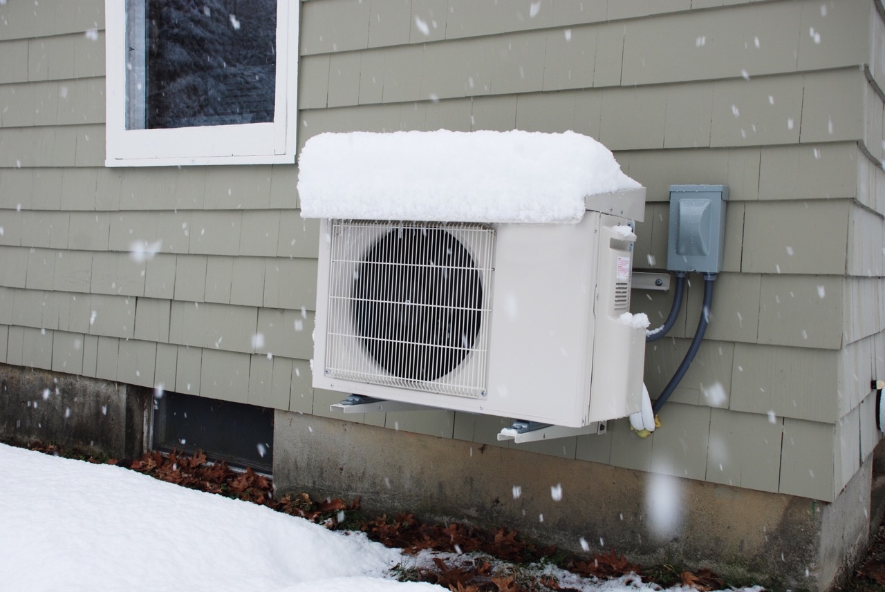 A heat pump covered with snow
